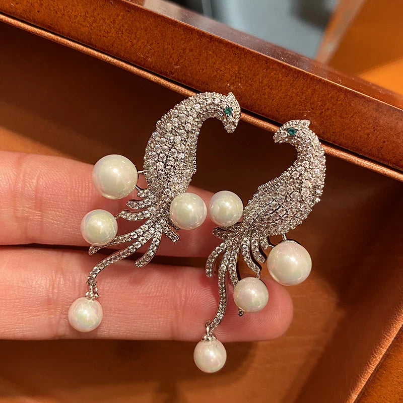 Elegant bird-themed pearl and tassel stud earrings in a versatile design