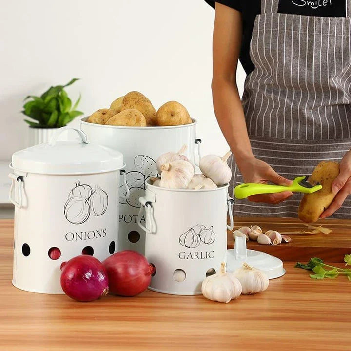 Breathable metal storage bins with handles for storing fresh produce like onions, potatoes and garlic in the kitchen.