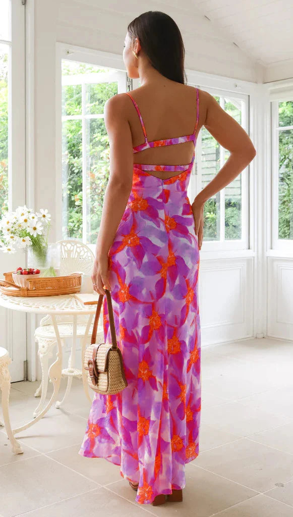 Stylish sleeveless backless midi dress with a vibrant floral print, perfect for any occasion