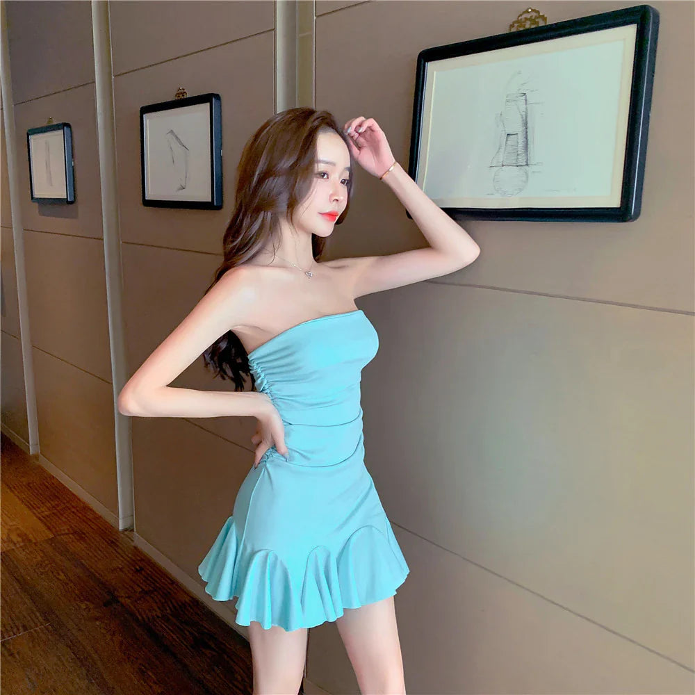 A stylish off-the-shoulder dress with ruffled hip detail, available in black and lake blue colors