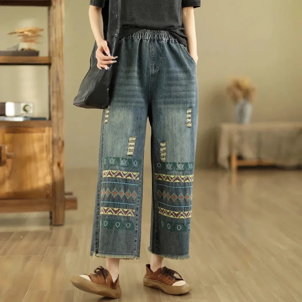 Vintage-inspired embroidered wide-leg jeans in a relaxed, bohemian style with a high-waist design and elastic closure for a personalized fit
