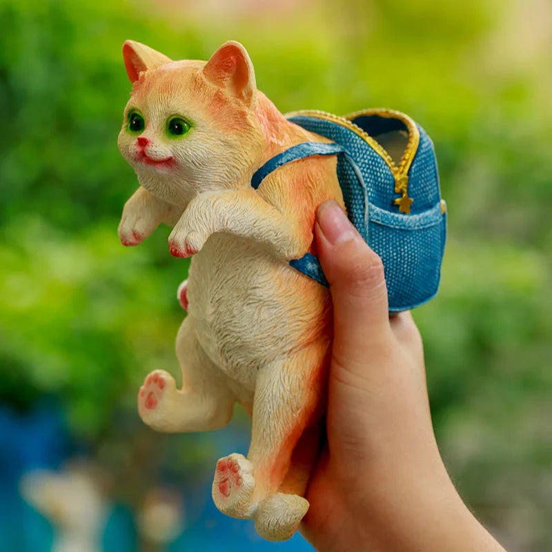 Charming cat backpack-shaped garden ornament made of weather-resistant resin, perfect for adding Kiwiana style and storage to your outdoor space