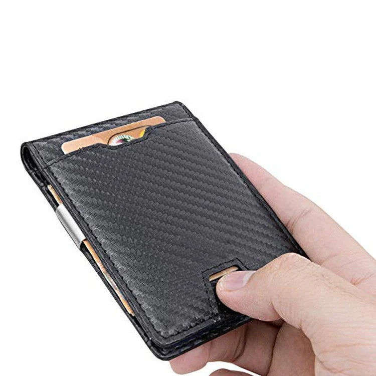 A stylish black leather card holder with a money clip, featuring carbon fibre accents for a sleek, modern look.