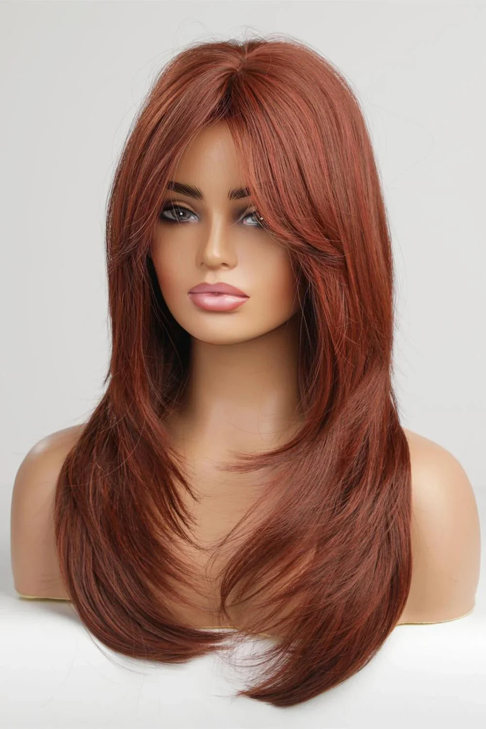 Model wearing a mid-length wave synthetic wig in a vibrant brick color