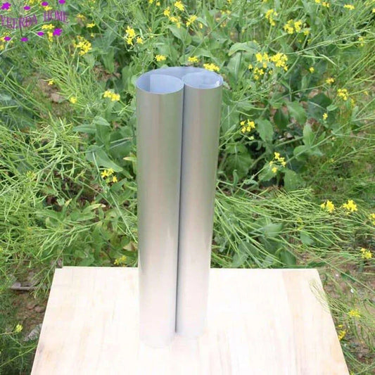 Reflective beehive sunshade covers protecting a backyard apiary from the sun's heat and UV rays