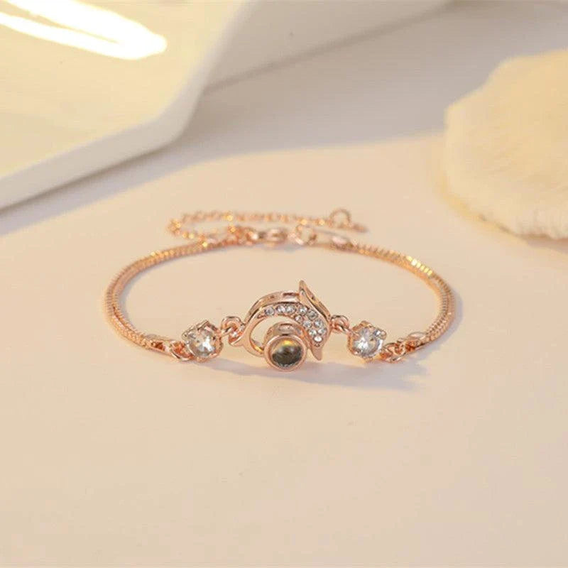 A pair of vibrant projection couple bracelets in rose gold and platinum colors