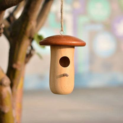 Charming wooden hummingbird nest in a Kiwi garden, designed to attract and shelter local bird species