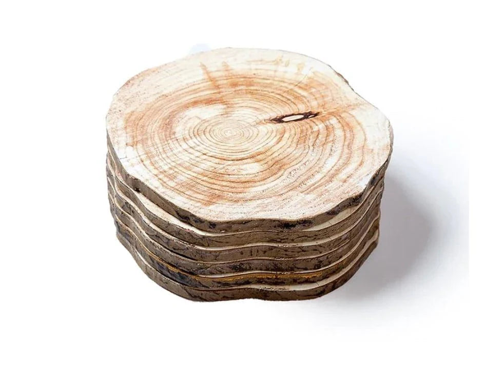 Set of 6 natural timber coasters in various grain patterns, protecting a mug on a wooden surface