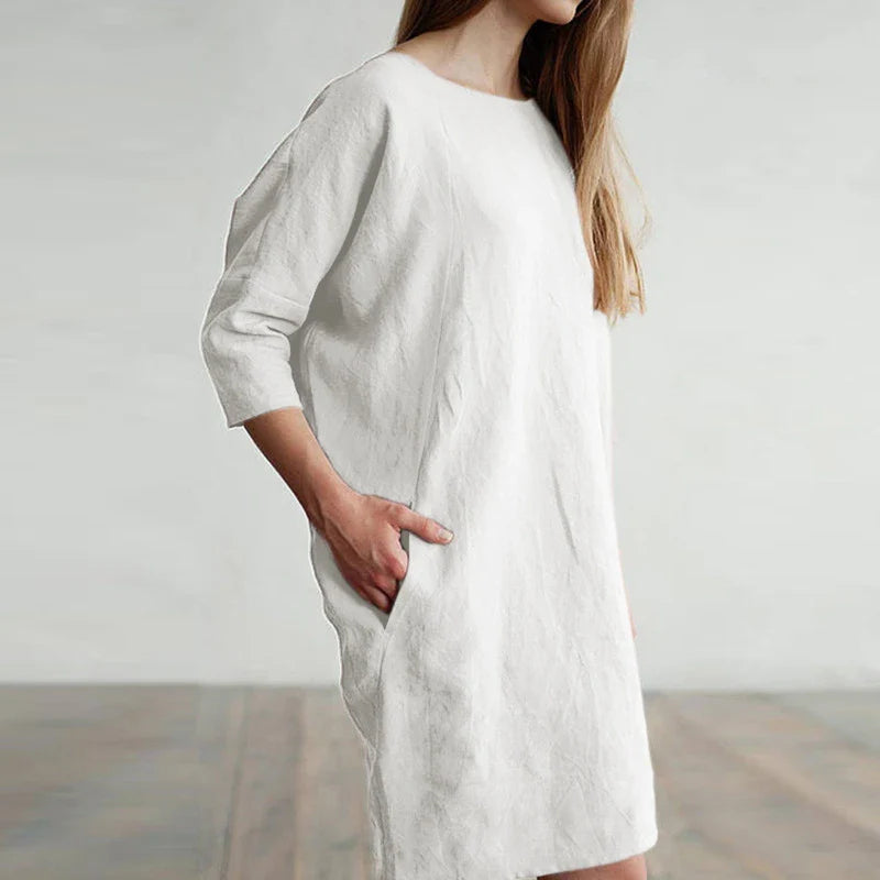 A cotton and linen dress with a round neckline, pockets, and an A-line silhouette in various colors.