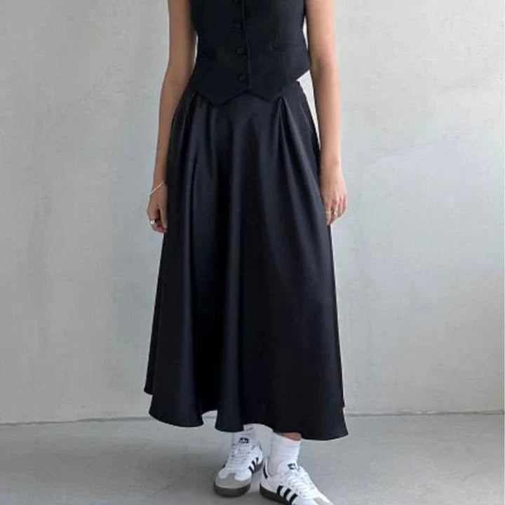 Elegant black satin maxi skirt with flattering empire waistline and ankle-length A-line silhouette, suitable for both formal and casual wear.