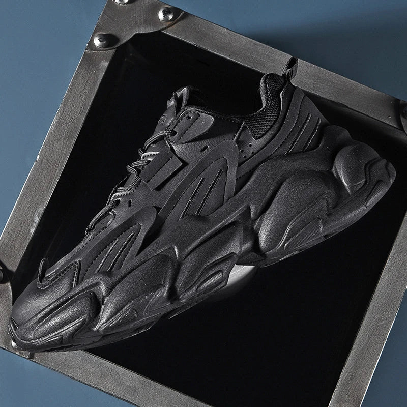 Pair of white, black, and gray casual sports sneakers with leather upper and rubber sole