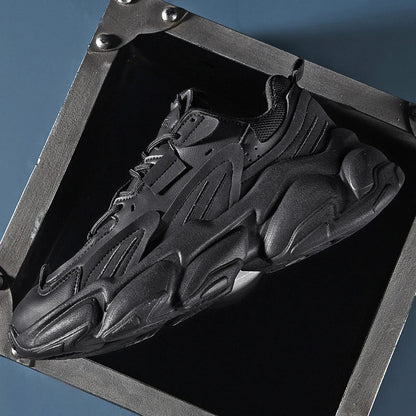 Pair of white, black, and gray casual sports sneakers with leather upper and rubber sole