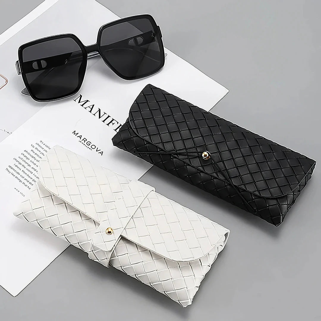 Stylish black and white twist braided leather sunglasses case with snap closure, protecting eyewear in a fashionable way