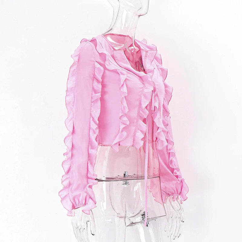 A pink ruffled crop top with a heart-shaped bow accent, made from stretch chiffon fabric for the modern Kiwi girl's style.