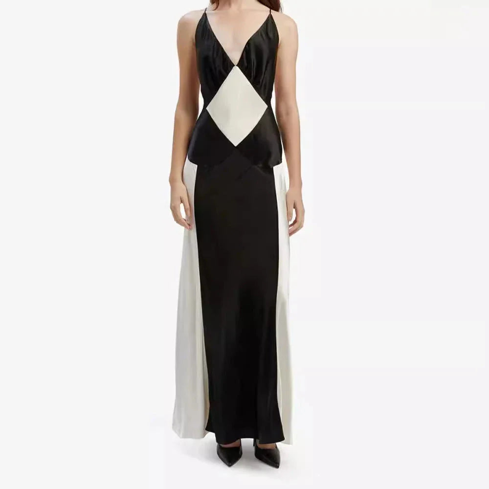 A sleeveless, long sling dress with a geometric black and white pattern, featuring an A-line silhouette and high-waist design.