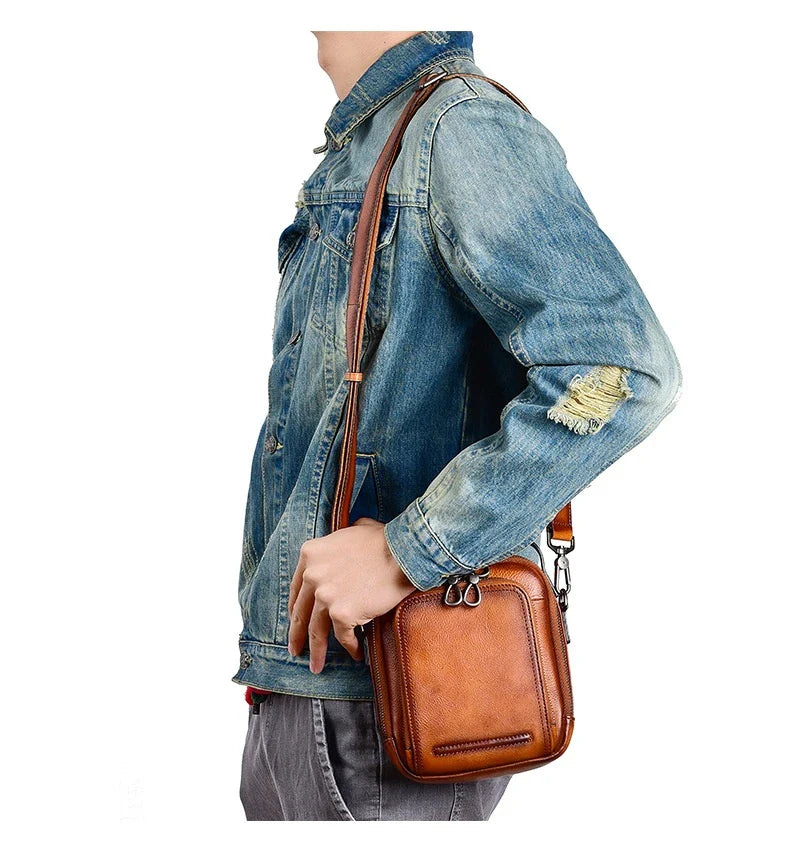 A rugged, retro-inspired cowhide messenger bag made in New Zealand, featuring a spacious interior, multiple pockets, and a comfortable single strap design.