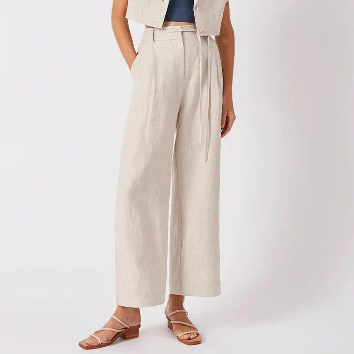 Elegant high-waist linen trousers with Korean-inspired design, featuring lace-up detail and button decorations for a sophisticated and comfortable look.