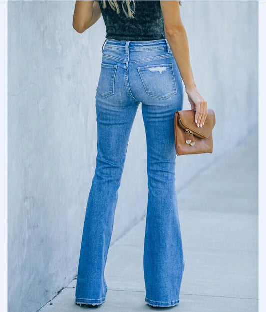 Stylish women's denim trousers with ripped and washed details, perfect for casual or dressy occasions