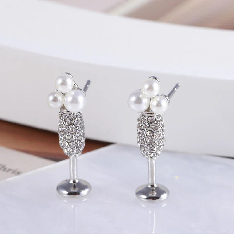 Stunning silver-plated earrings featuring a pearl inlay design, perfect for adding a touch of elegance to any outfit.