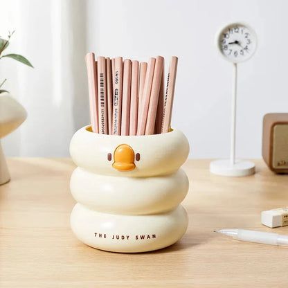 Adorable cartoon-style plastic pen holder with a large capacity for storing pens, pencils, and other desk essentials