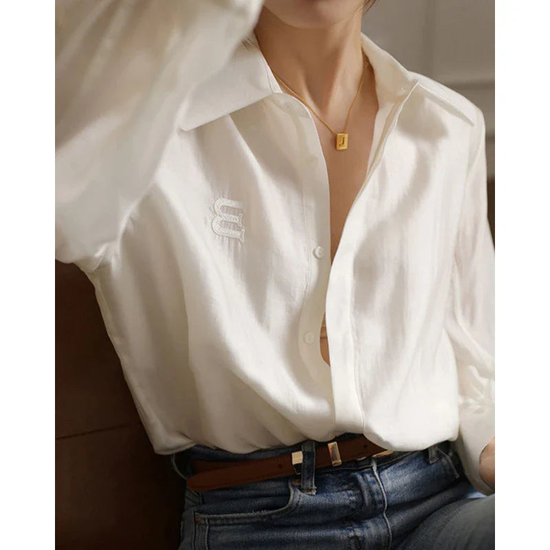 A stylish and comfortable white chiffon blouse for Kiwi women, featuring a classic cardigan design and versatile, high-quality construction.