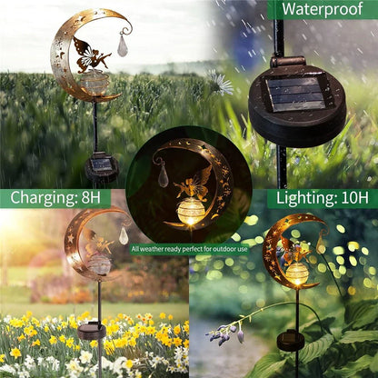 Decorative solar-powered fairy garden light with a glass globe and moon and fairy design for outdoor illumination