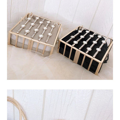 A stylish Kiwi-designed diamond-studded dinner bag with metallic accents, showcasing a range of premium features like lace, plaid, and sequins.