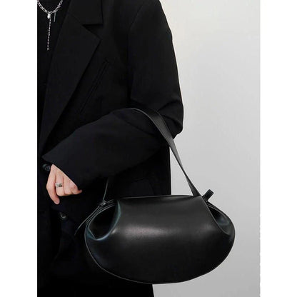 A stylish circular vegan leather handbag with a unique rugby-inspired design, perfect for Kiwi fashion enthusiasts