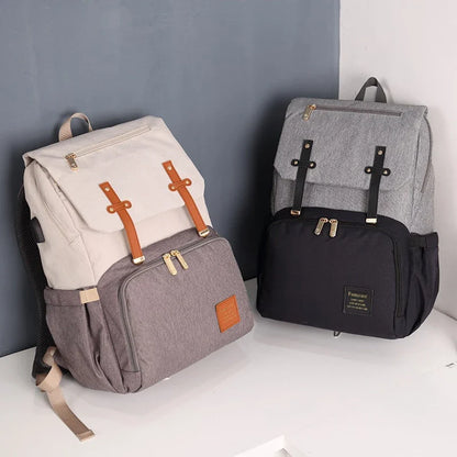 Versatile Mummy Daddy Backpack in Grey, a functional and stylish nappy bag for Kiwi families with a spacious main compartment, insulated pockets, and a USB charging port.