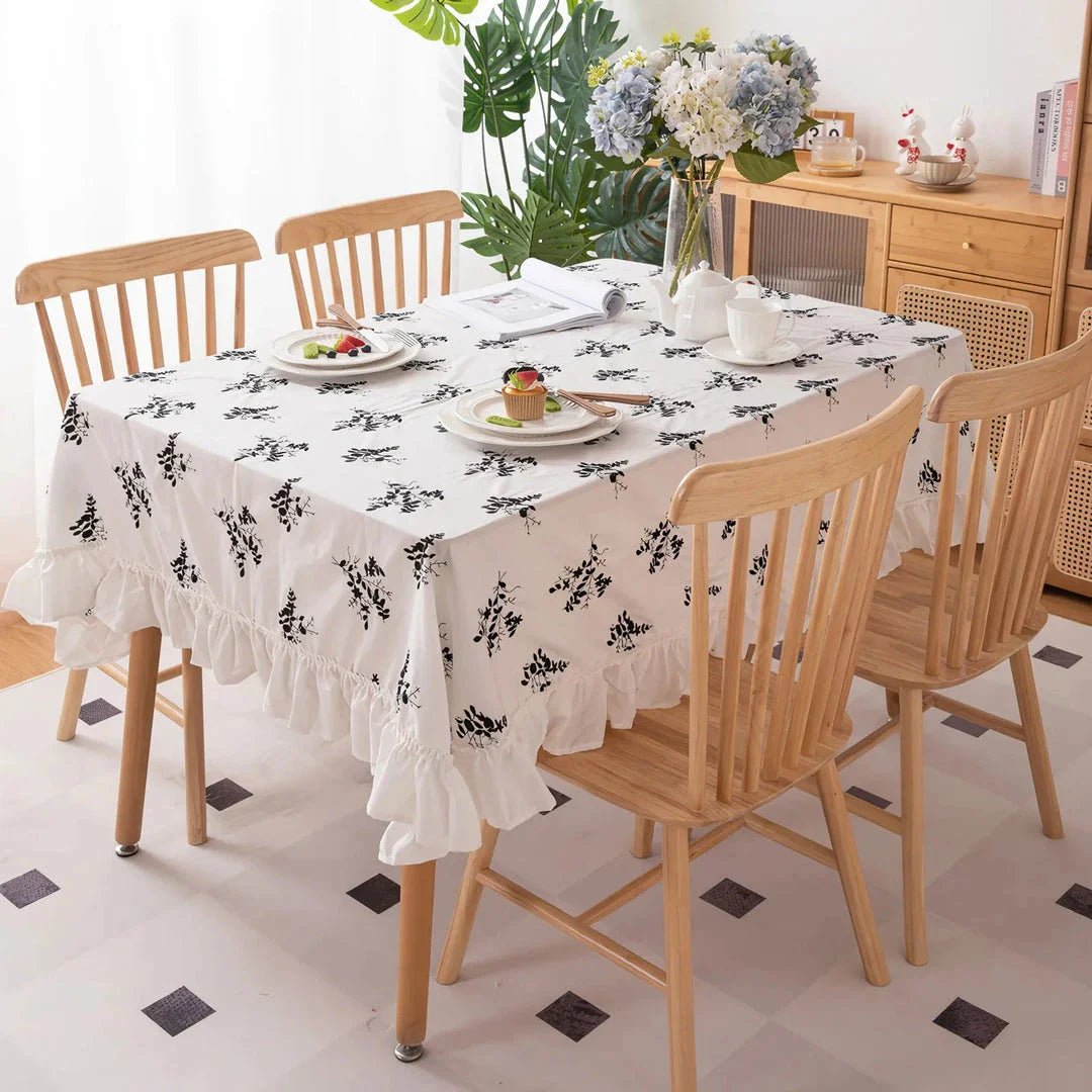 Elegant embroidered floral cotton tablecloth with ruffled edges, perfect for Kiwi homes and hospitality