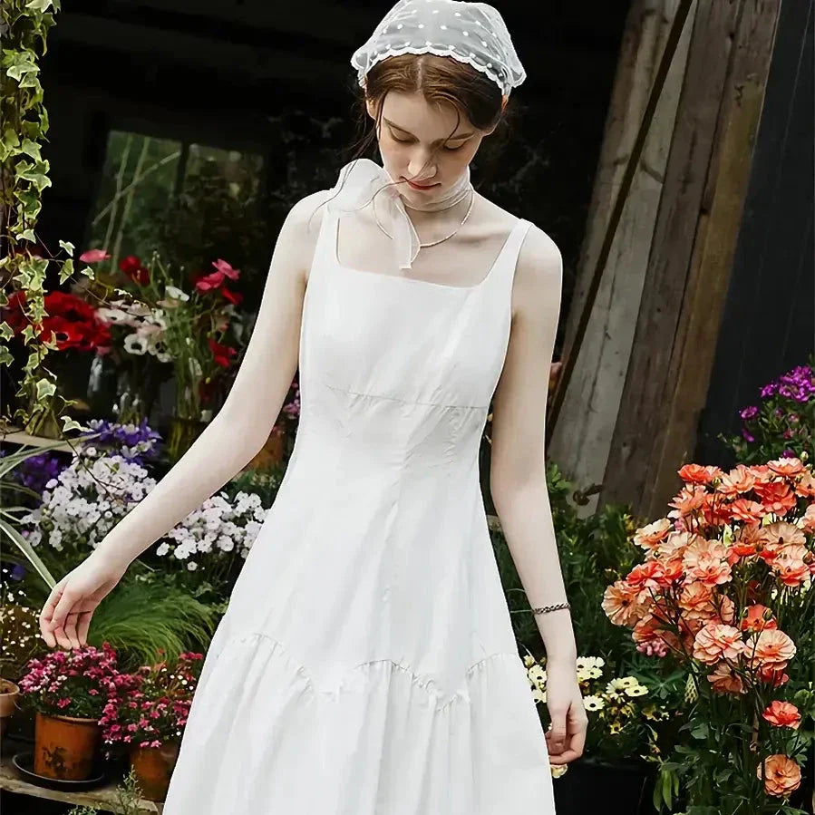 A French-inspired white suspender long dress made of 100% premium cotton for effortless elegance and all-day comfort.