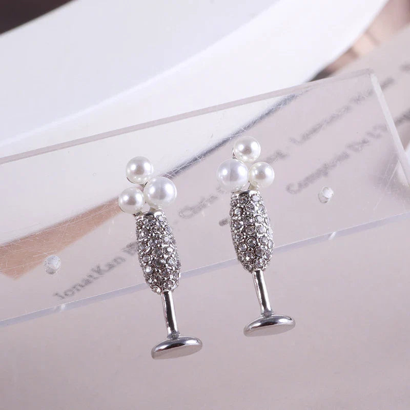 Stunning silver-plated earrings featuring a pearl inlay design, perfect for adding a touch of elegance to any outfit.