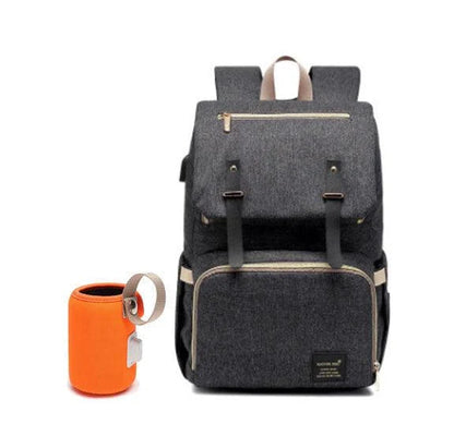 Versatile mum's backpack with pink color, featuring side pockets, zippered compartments, and stroller attachment hooks