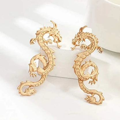 Captivating dragon-shaped stud earrings in gold, a unique New Zealand accessory that adds modern flair to any outfit.