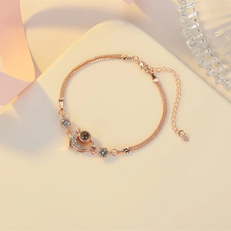 A pair of vibrant projection couple bracelets in rose gold and platinum colors