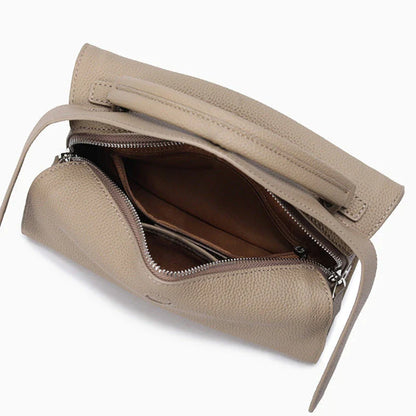 Premium cowhide leather crossbody bag with a unique pillow-shaped design, multiple interior pockets, and an adjustable strap for comfortable everyday wear.