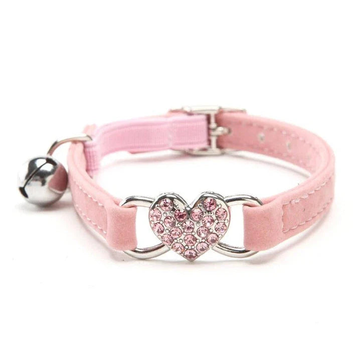 A stylish cat collar made of premium velvet material, featuring a heart-shaped charm and jingle bell for a playful touch.