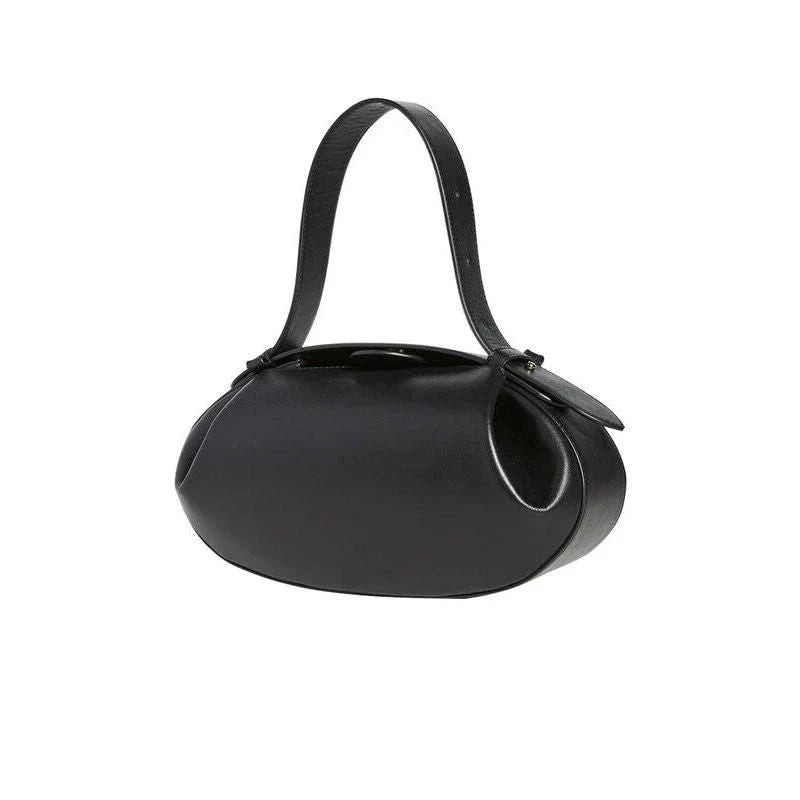 A stylish circular vegan leather handbag with a unique rugby-inspired design, perfect for Kiwi fashion enthusiasts