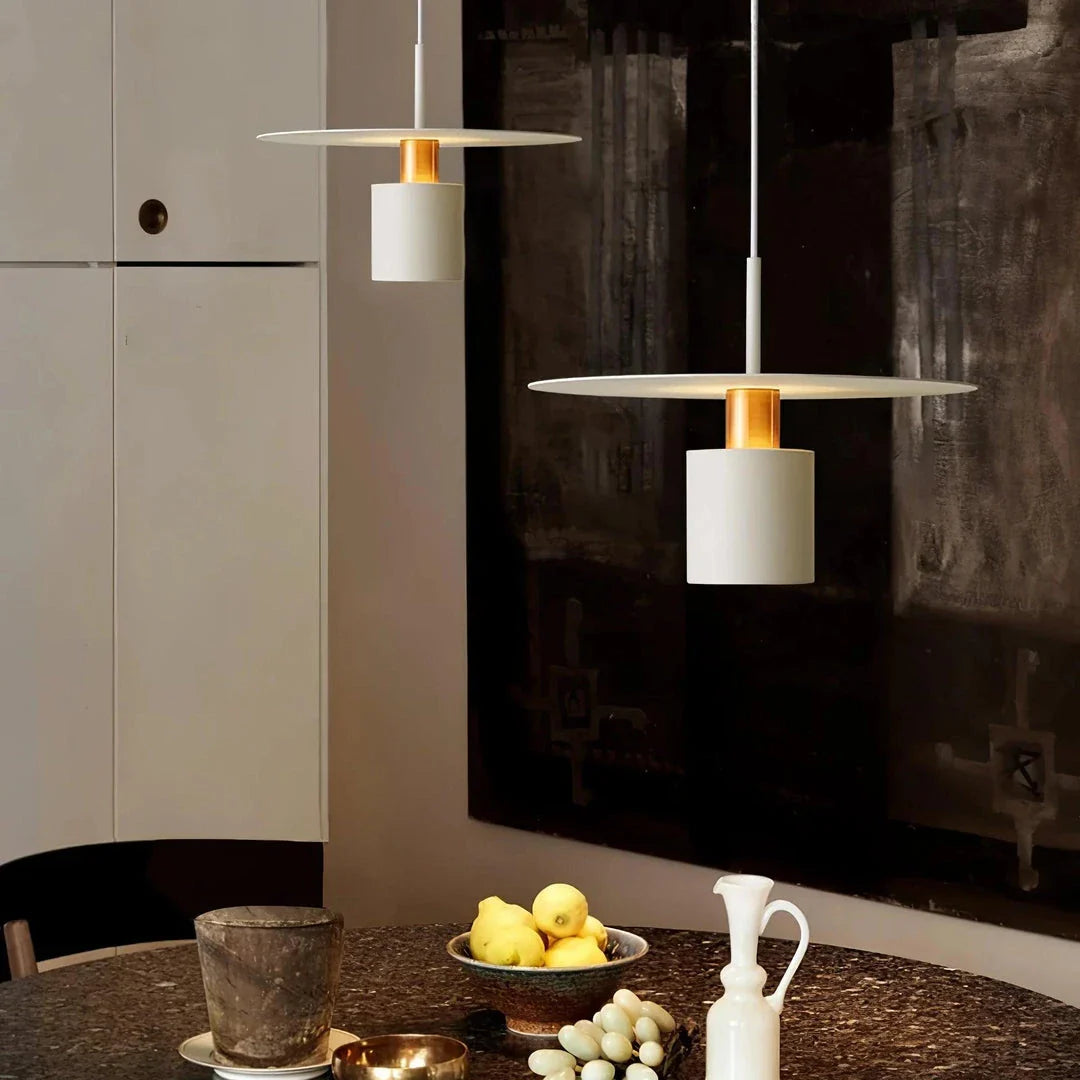 A modern, minimalist pendant light with a sleek, painted metal design, perfect for enhancing the ambiance of cafes, bedrooms, and other contemporary interior spaces.