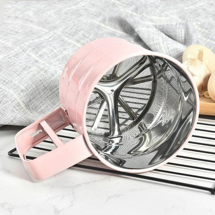 Elegant macaron pink handheld flour sifter with stainless steel construction, perfect for Kiwi bakers