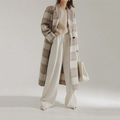 A stylish plaid double-breasted long wool coat for fashionable Kiwi women, featuring a cozy and elegant design with functional pockets and a versatile turn-down collar.