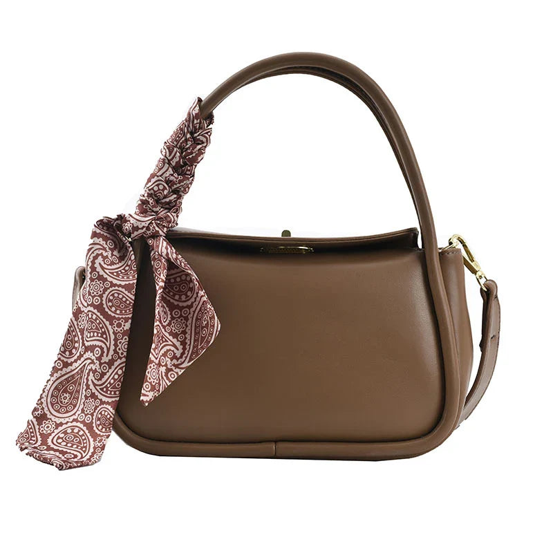 Premium silk scarf handbag in a variety of Kiwi-approved colours, featuring a magnetic buckle closure and oval shape for ample storage.