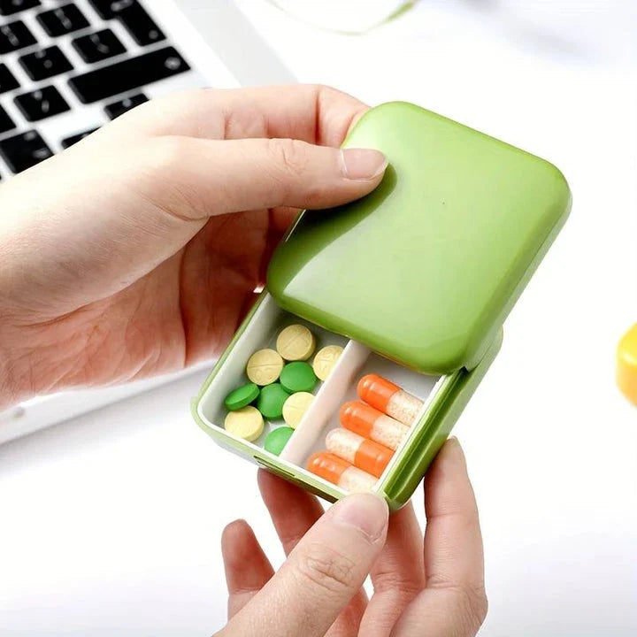 A compact, push-pull pill organiser in a vibrant green colour with cartoon-inspired design