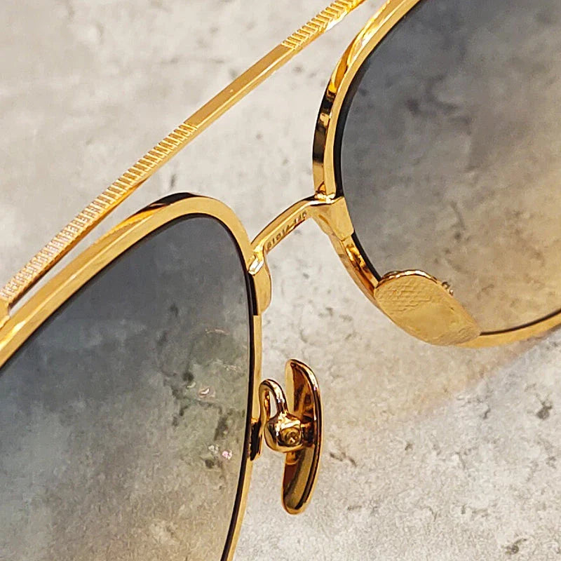 Premium pure titanium pilot sunglasses with a luxurious gold finish, offering superior UV protection and timeless vintage-inspired design.