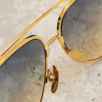 Premium pure titanium pilot sunglasses with a luxurious gold finish, offering superior UV protection and timeless vintage-inspired design.