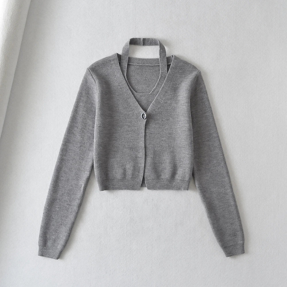 Stylish knitwear vest in a classic black or neutral colour, featuring a V-neck collar and long sleeves for a polished, versatile look.