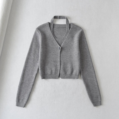 Stylish knitwear vest in a classic black or neutral colour, featuring a V-neck collar and long sleeves for a polished, versatile look.