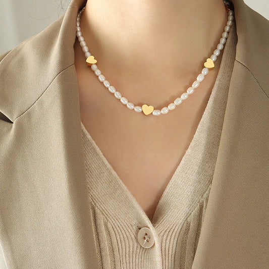 Peach Heart Freshwater Pearl Necklace with a delicate heart design and shimmering pearls, made of durable titanium steel for long-lasting wear