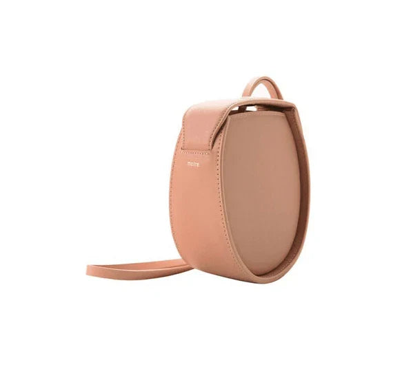 Versatile drawstring shoulder bag in pink with artificial leather construction and diagonal design