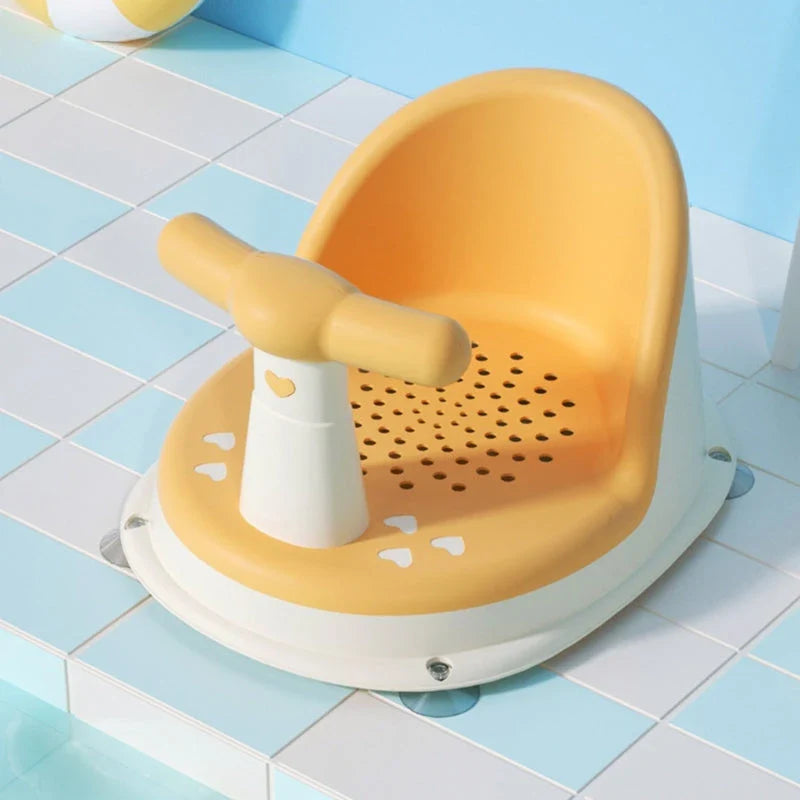 A green, ergonomically designed infant bath tub with large suction cups on the bottom to prevent slipping or tipping.